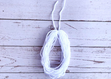 Next, remove the card with care from the wrapped yarn.