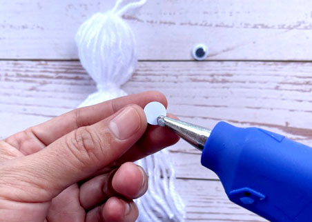 Using a glue gun, add a pair of googly eyes on the opposite side of the "neck."